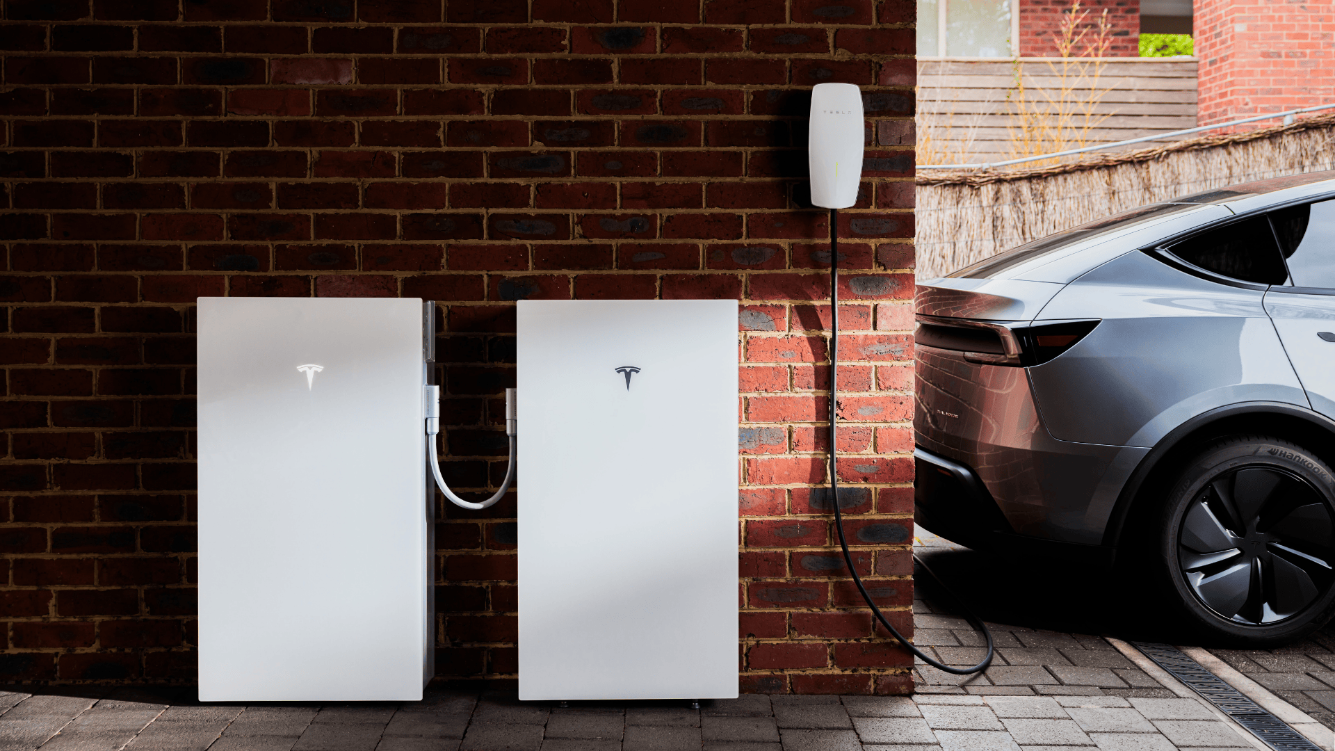 Tesla Powerwall 3, expansion pack and wall connector in a garage