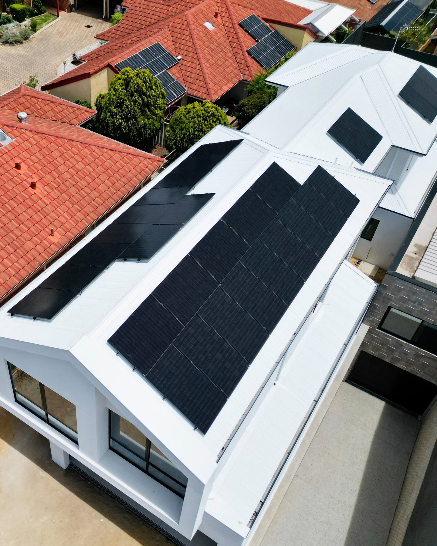 Jinko Neo Satin all-black solar panels installed by Perth Solar Warehouse on a suburban rooftop in Scarborough, Western Australia on a white roof top.