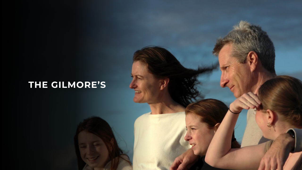 Tesla Live on Sunshine winners the Gilmore's pictured as a family looking towards the ocean with the sun in their face.